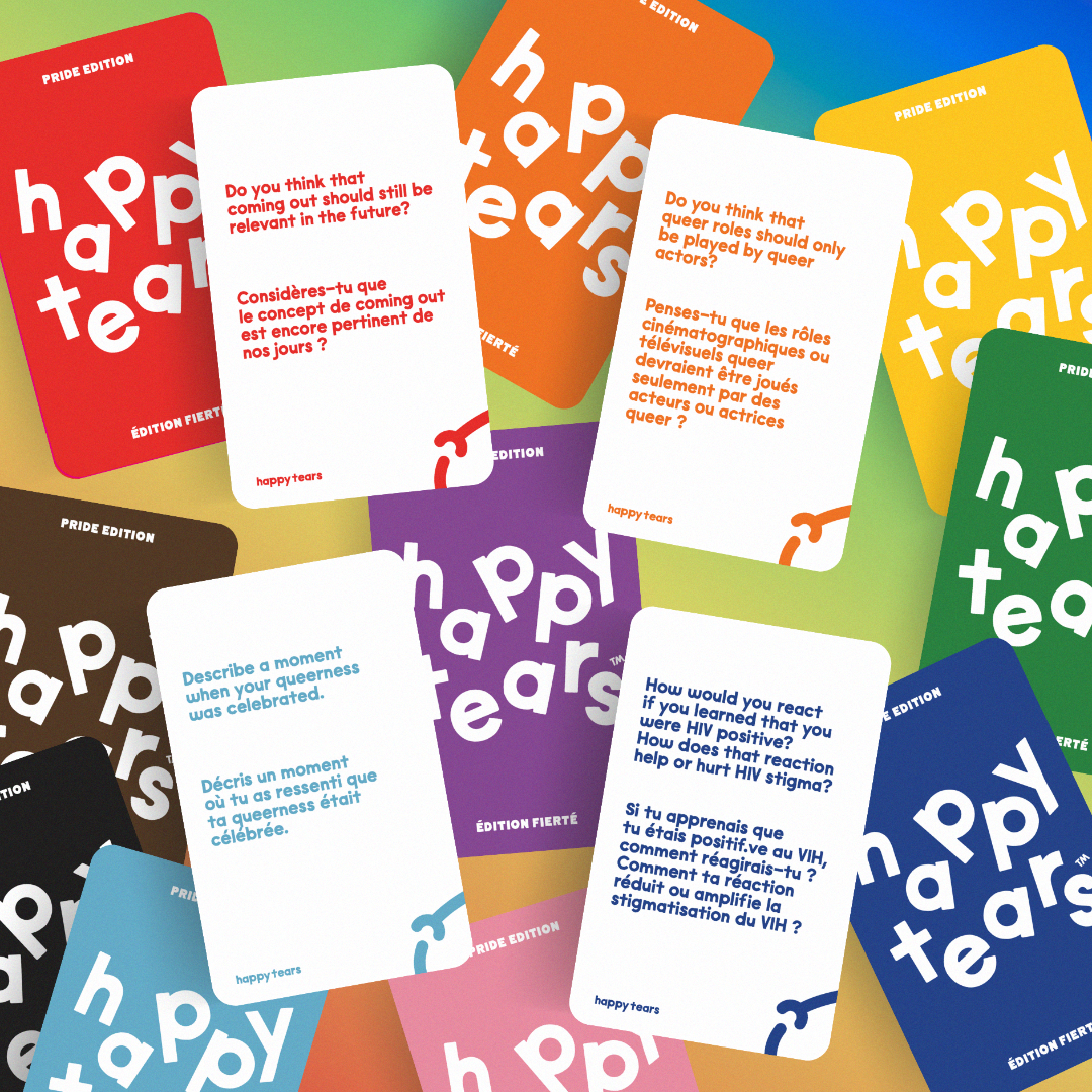 Pride conversation cards. Grey drawstring bag, multicoloured cards. Cards: 'happy tears', rainbow design. Bag text: 'For queerful connections', 'Pour les connexions queer'.