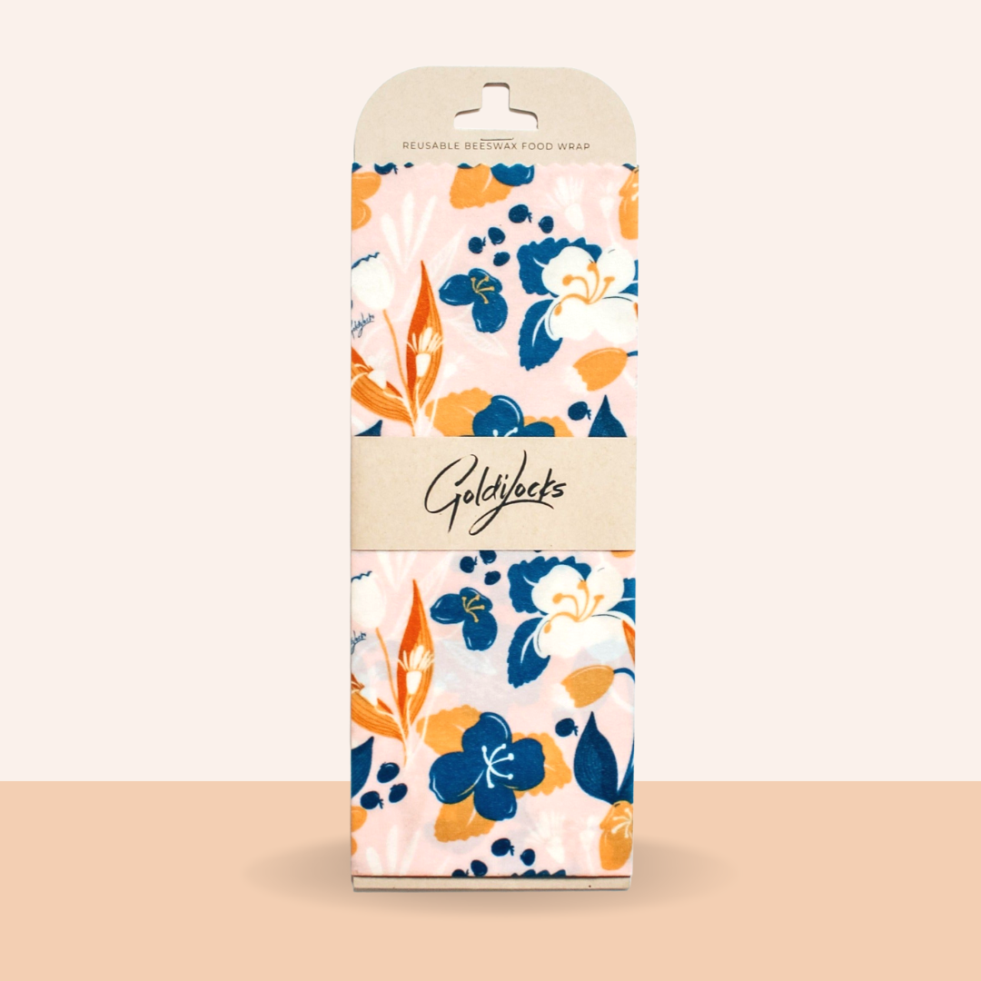 Packaging of Goldfleck reusable beeswax food wrap with floral design on a beige background