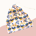 Floral-patterned bag with blue and yellow flowers on a light pink background