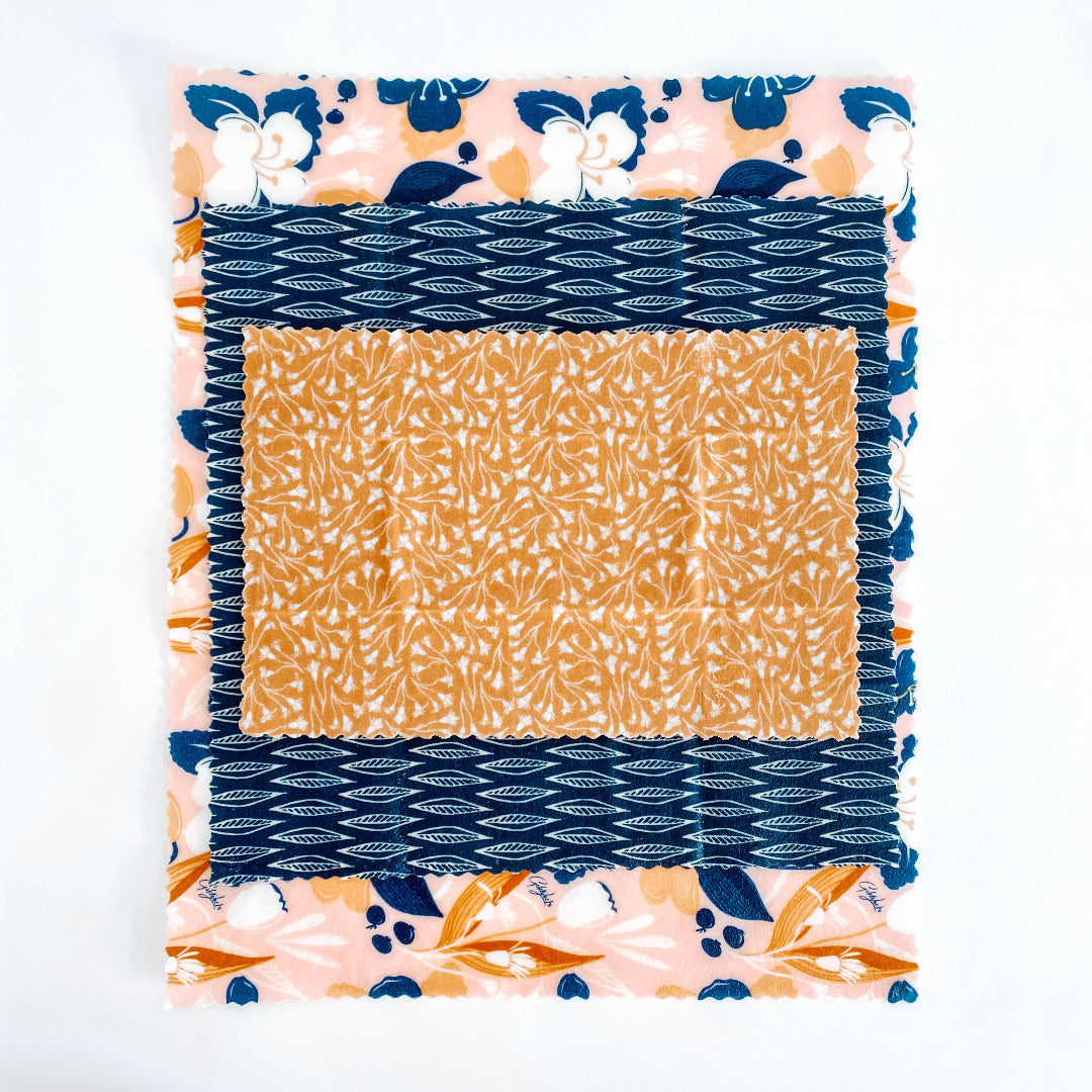 Fabric square with blue, orange, and floral patterns on a white background