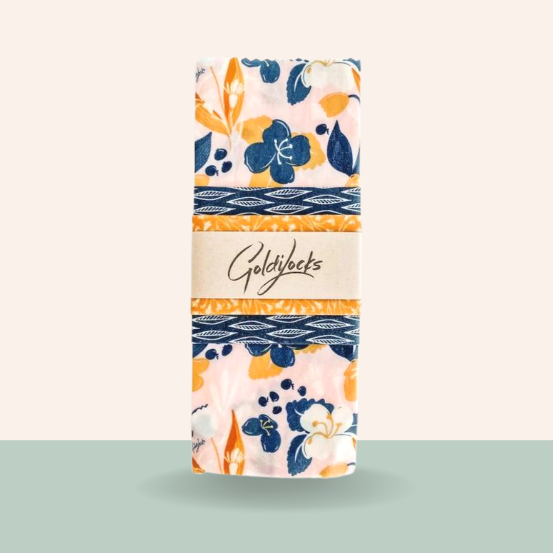Packaged product with floral design and 'Goldylocks' branding on a light green background