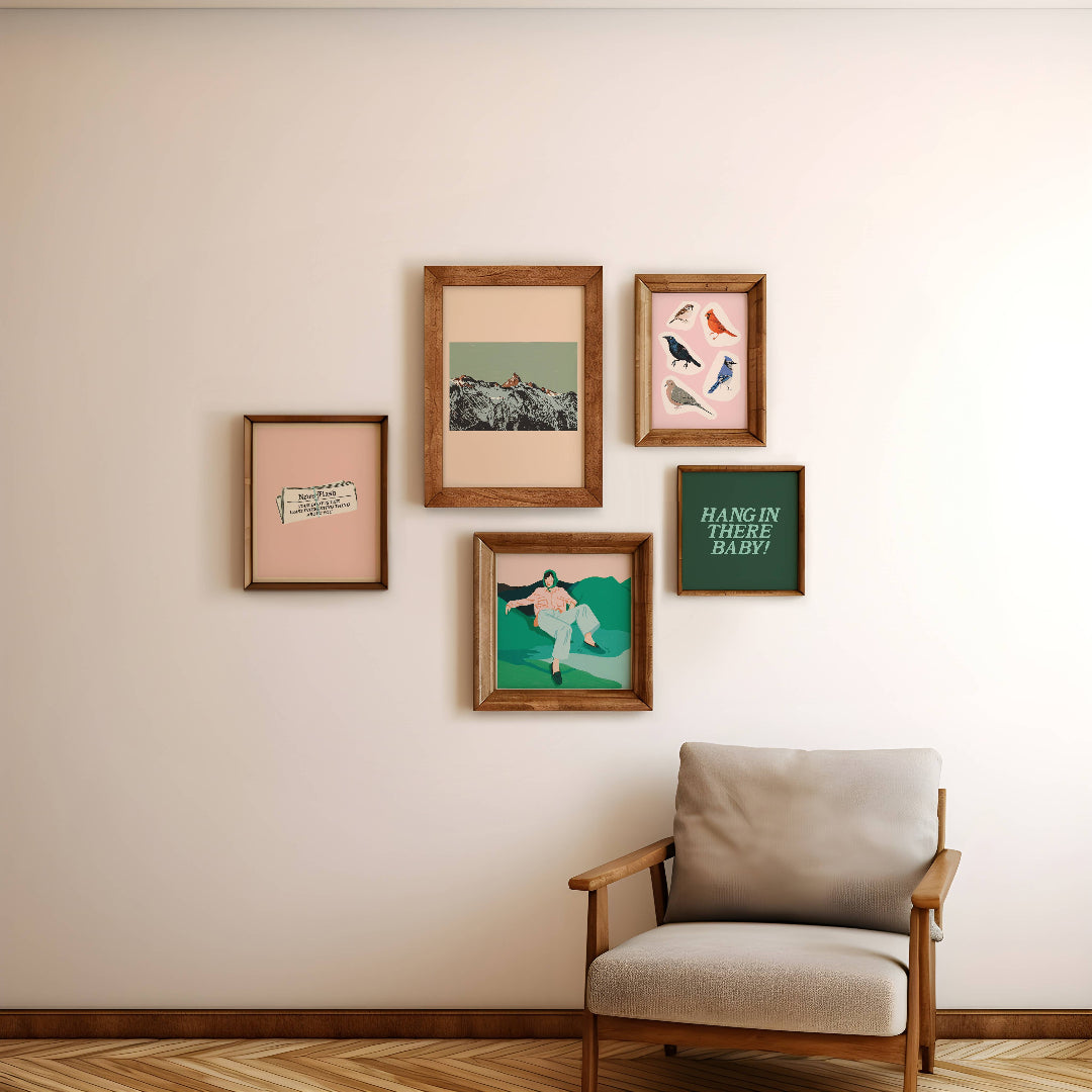 Framed artworks on a wall with a chair below