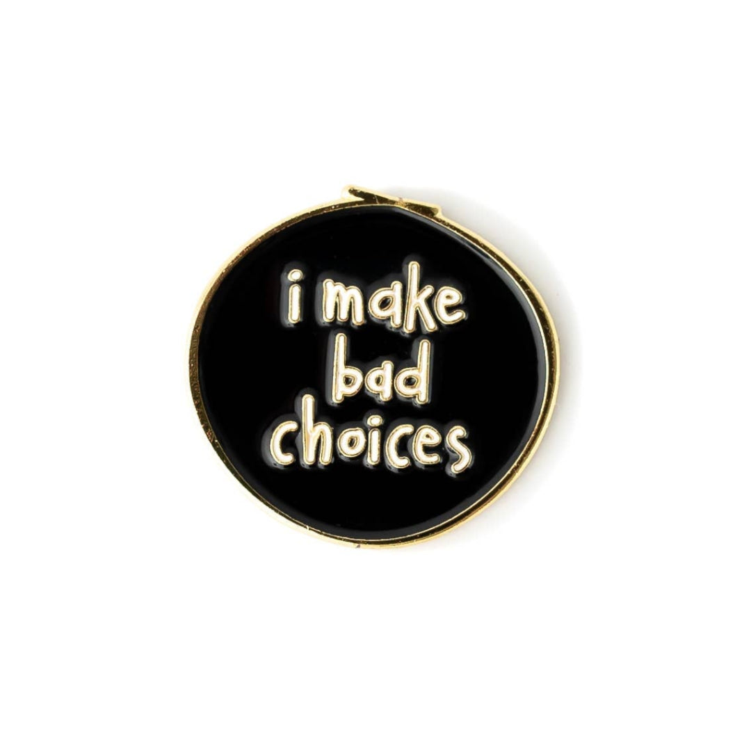 Black round enamel pin with 'i make bad choices' text on a white background