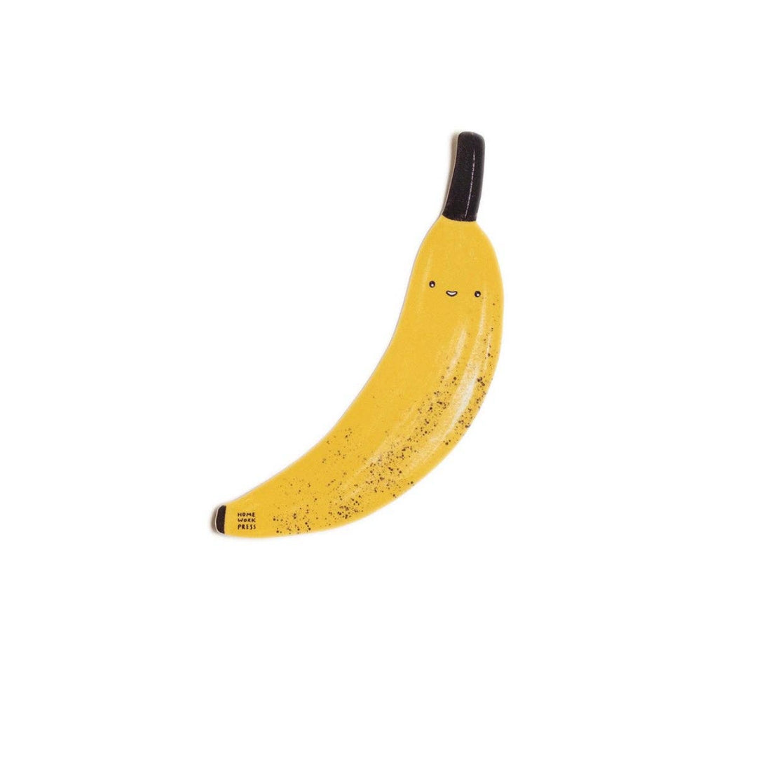 Yellow banana with a face on a white background