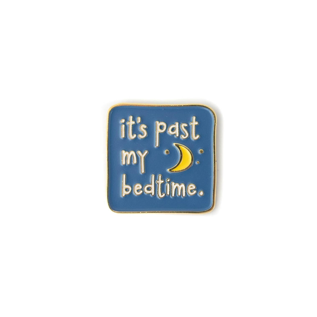 Enamel pin with 'it's past my bedtime' text and moon symbol on a blue background