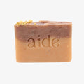 Bar of soap with 'aide' branding on a white background
