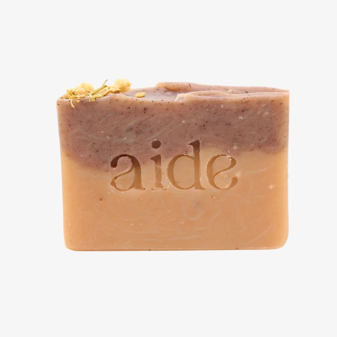 Bar of soap with 'aide' branding on a white background