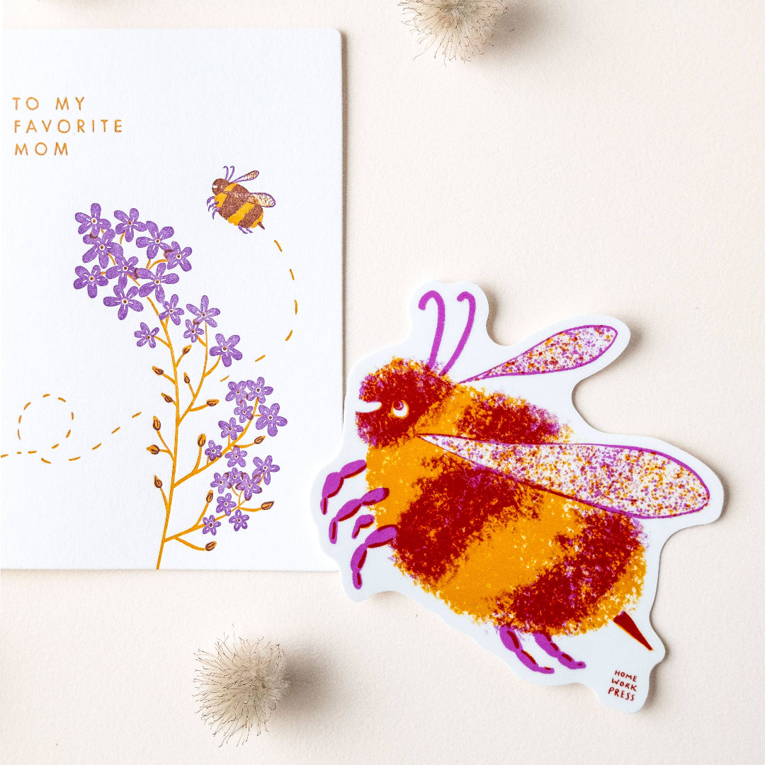 Colorful bee-shaped card with a floral design and 'To My Favorite Mom' text on a light background.