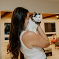 Woman holding a cat in a living room