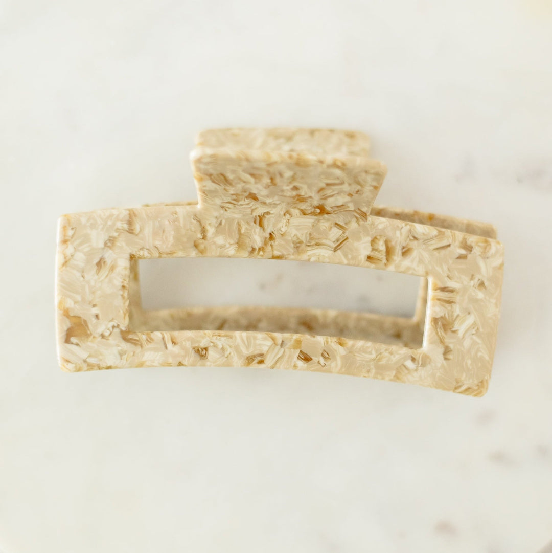 Two rectangular pieces of tofu on a white marble surface