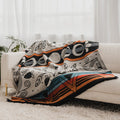 Colorful patterned blanket draped over a white sofa with a light background