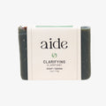 Bar of soap with 'aide' branding on a white background