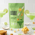 Eatable Coconut Lime Margarita popcorn package with popcorn and drinks on a table
