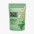 Eatable Coconut Lime Margarita popcorn bag on a green background