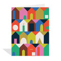 White greeting card featuring rows of brightly coloured, abstract house illustrations in shades of pink, blue, green, yellow, orange, brown, and white, with the word "HOME" written in orange on one of the houses. Illustrated by Hannah Beisang.