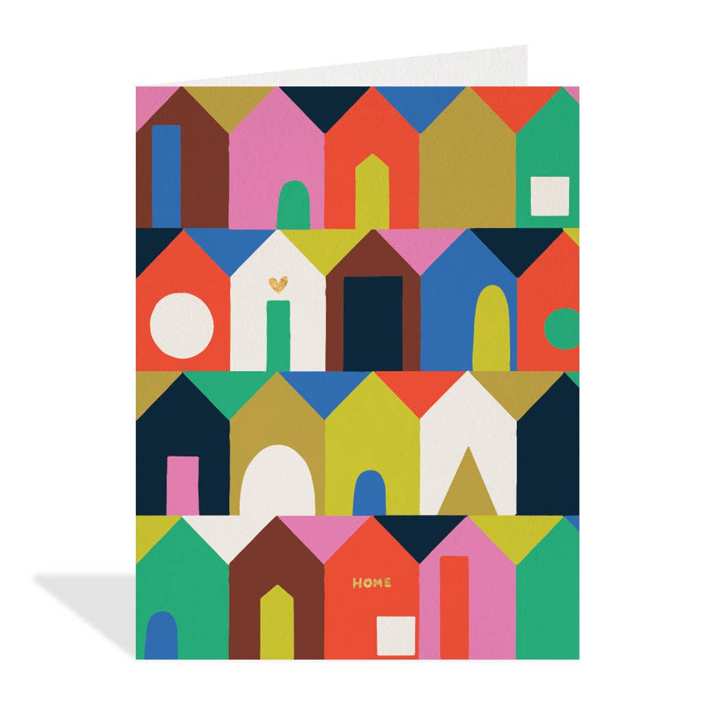 White greeting card featuring rows of brightly coloured, abstract house illustrations in shades of pink, blue, green, yellow, orange, brown, and white, with the word "HOME" written in orange on one of the houses. Illustrated by Hannah Beisang.