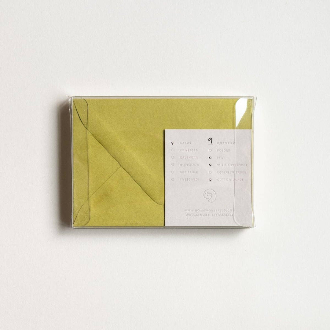 Green envelope with a white card inside on a light gray background