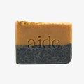 Two-toned bar of soap with 'aide' branding on a white background