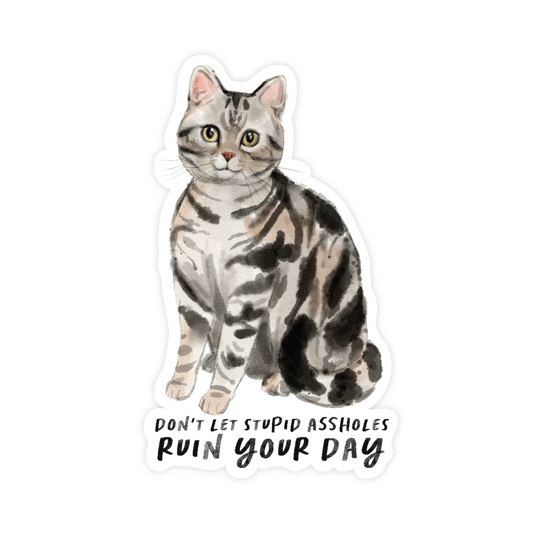 Sticker of a cat with text 'Don't let stupid assholes ruin your day' on a white background