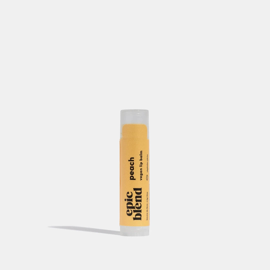 A yellow tube of Epic Blend Peach Vegan Lip Balm. The label on the tube features the product name and indicates that it is vegan.