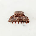Brown hair clip on a white background