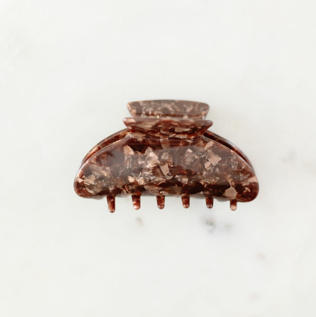 Brown hair clip on a white background
