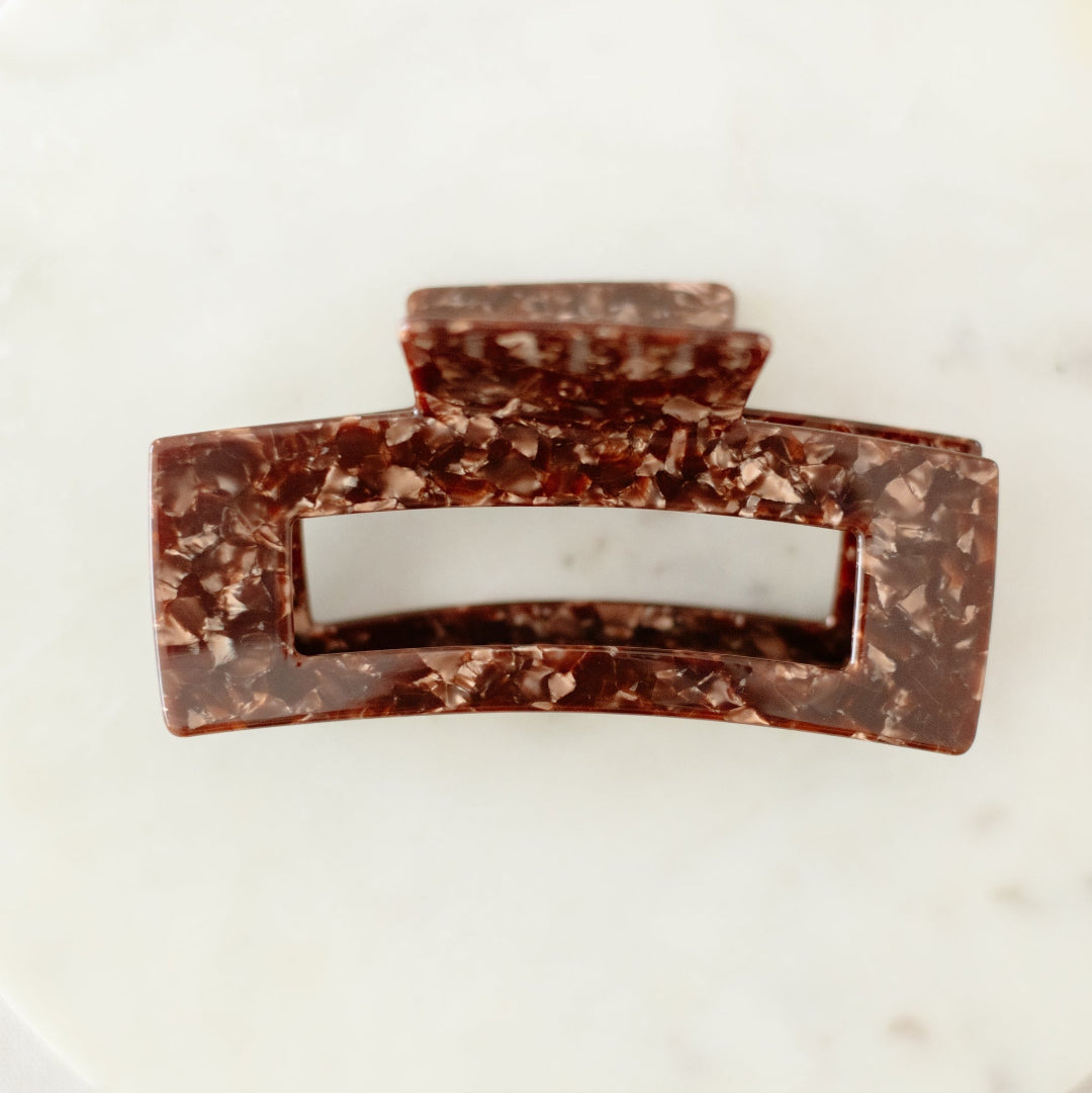 Chocolate bar with a marble pattern on a white plate