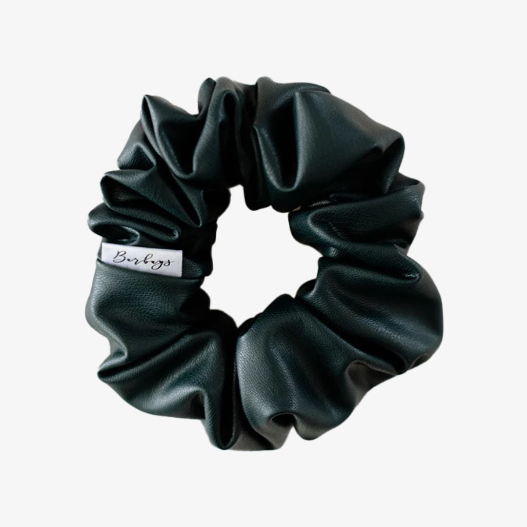 Black scrunchie with a brand label on a white background