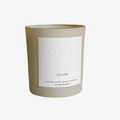 A beige glass jar candle with a white label. The label reads "NORTH ROSE" and "FIRESIDE."