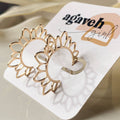 Gold sun-shaped earrings on a 'agaveh girl' branded card.
