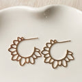 Gold hoop earrings on a white dish