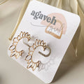 Gold sun-shaped earrings on a 'agaveh girl' branded card.