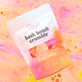 Packaged bath bomb crumble with 'fruit loops' text on a colorful background