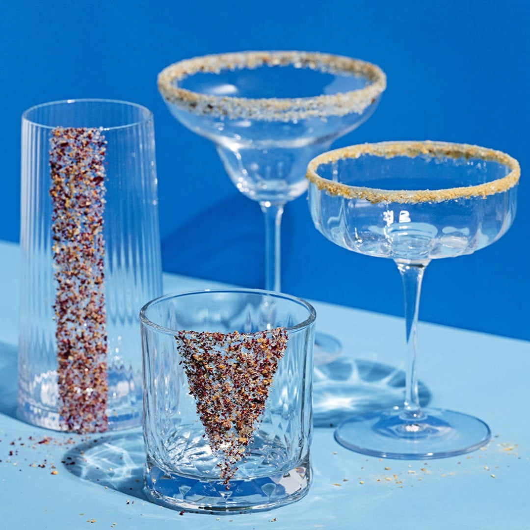 Set of glassware with decorative rims on a blue background