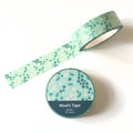 Roll of green floral washi tape on a white background