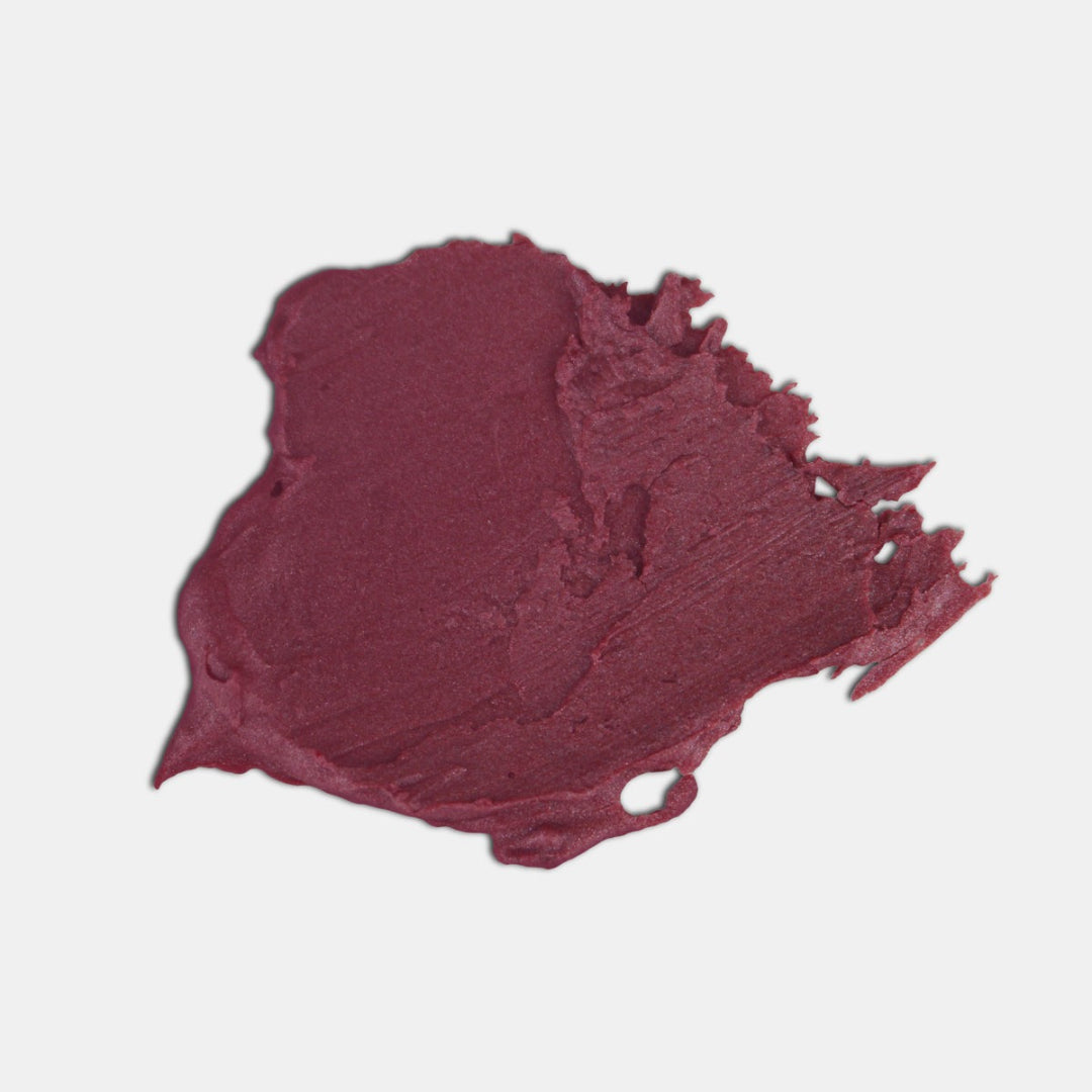 A white tube of Epic Blend Garnet Star Tinted Lip Balm with a deep pink label. The label displays the brand name, "garnet star tinted lip balm," and indicates it has a subtle shimmer.