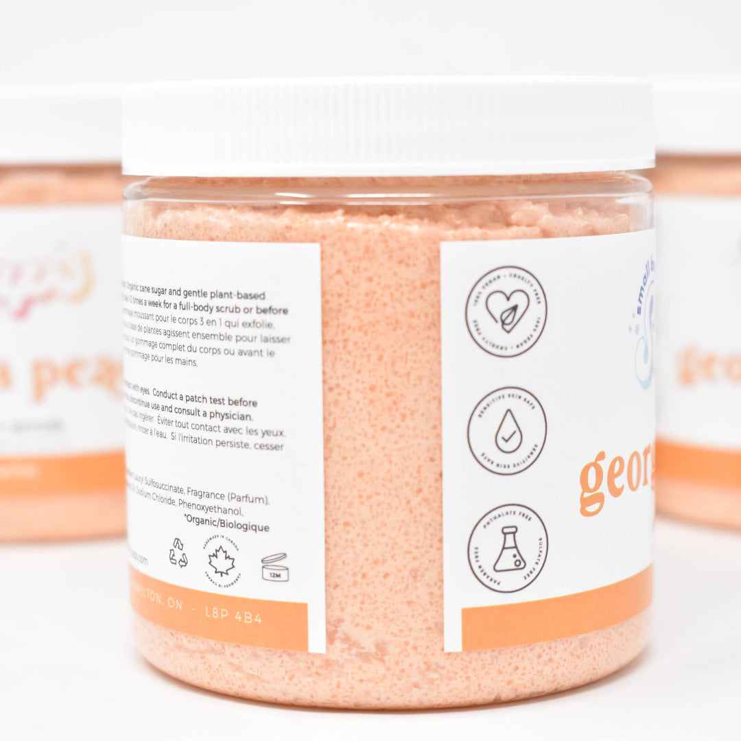 Three containers of 'Georgia Peaches' bath salts with visible labels on a white background.