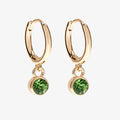 A set of three pairs of peridot earrings displayed on a green card. The set includes a pair of stud earrings, a pair of bar earrings with small peridot beads, and a pair of hoop earrings with dangling peridot stones. The card has the month "August" and the brand name "Foxy Originals."