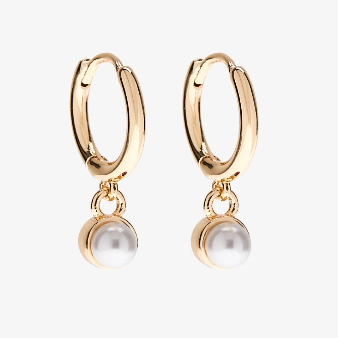 A set of three pairs of pearl earrings displayed on a blue card. The set includes a pair of stud earrings, a pair of bar earrings with small pearl beads, and a pair of hoop earrings with dangling pearl stones. The card has the month "June" and the brand name "Foxy Originals."