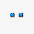 A set of three pairs of sapphire earrings displayed on a blue card. The set includes a pair of stud earrings, a pair of bar earrings with small sapphire beads, and a pair of hoop earrings with dangling sapphire stones. The card has the month "September" and the brand name "Foxy Originals."