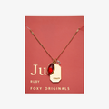 A gold necklace with a ruby stone pendant. The pendant also has the word "VITALITY" engraved on it. The necklace is displayed on a red card with the month "July" and the brand name "Foxy Originals."