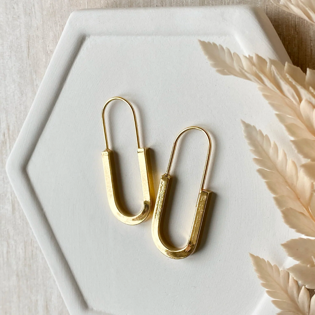 The Gold Minimalist Hoop is an ultra modern and sleek design and will be sure to keep you looking top notch. Nickel free and 14K gold plated.  Made in Canada. Close Up product image