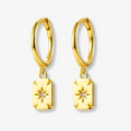 Gold plated rectangle drop earrings, potentially Bohomoon style, featuring small gold hoops with dangling rectangular charms, each with a central starburst design and a sparkling crystal. These modern earrings are available in Ottawa, Ontario, Canada.