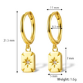Gold plated rectangle drop earrings, potentially Bohomoon style, featuring small gold hoops with dangling rectangular charms, each with a central starburst design and a sparkling crystal. These modern earrings are available in Ottawa, Ontario, Canada.