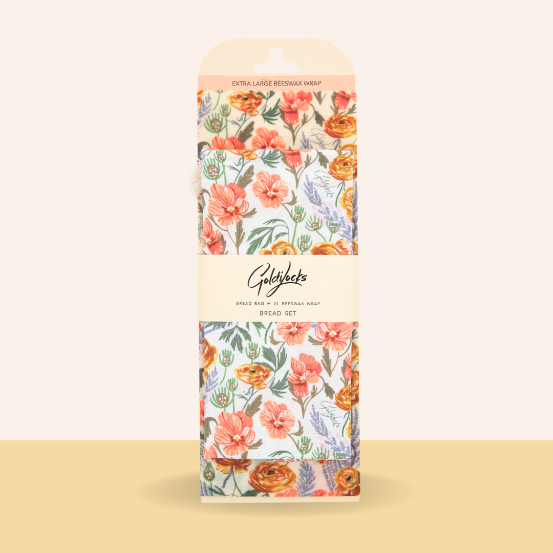 Floral-patterned packaging of Gold & Co. beeswax wraps on a beige background