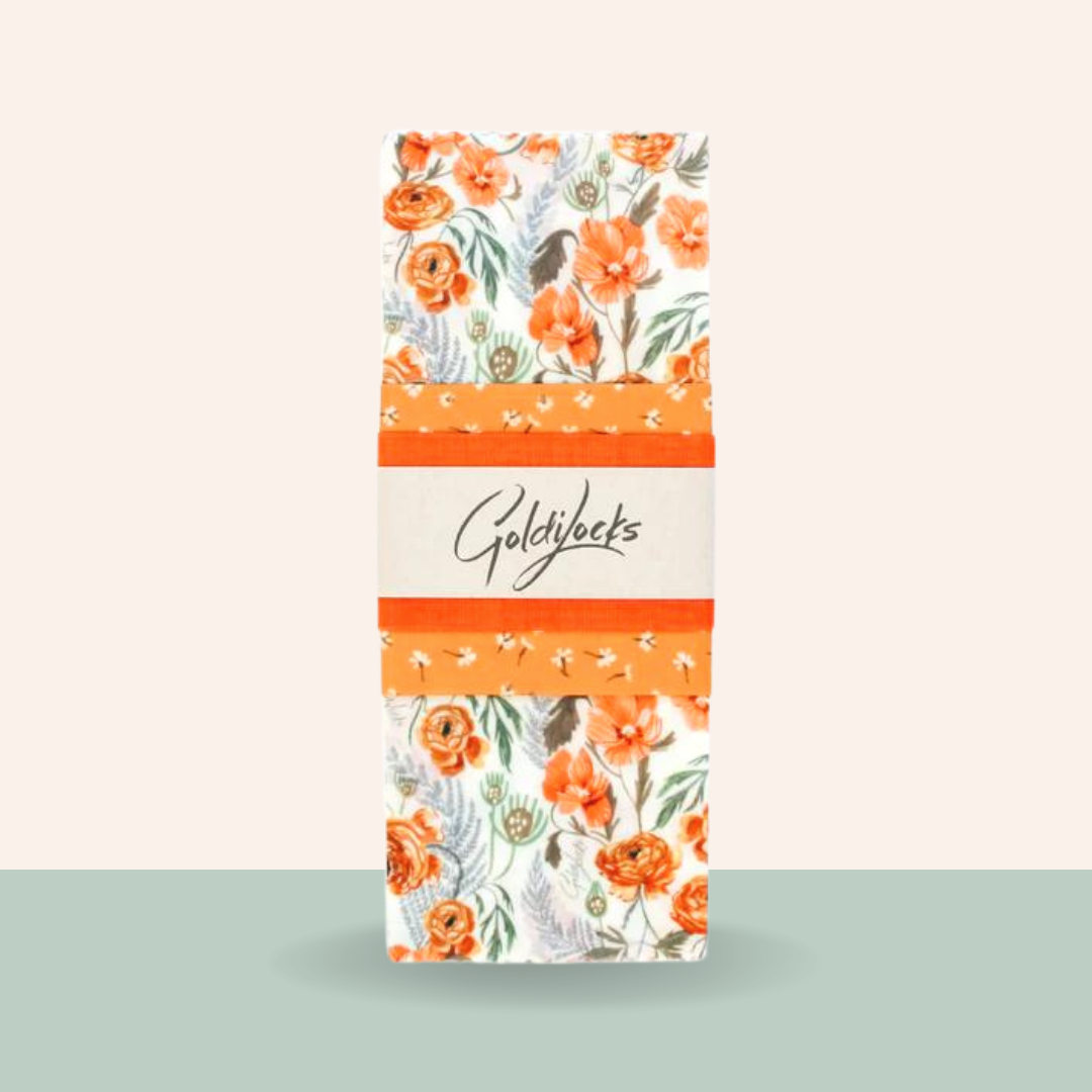 Floral-patterned product packaging with 'Goldylocks' branding on a light background
