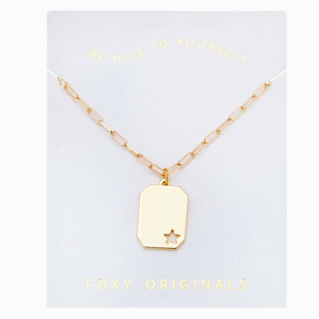 Gold necklace with a star pendant on a white card with 'Foxy Originals' branding.