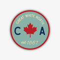 A circular sticker with a red outer border and a light teal inner circle. It features a bold red maple leaf in the centre, flanked by a dark blue 'C' on the left and a dark blue 'A' on the right. Above the leaf, it reads "GREAT WHITE NORTH" in a light cream font, and below, "est 1867" in the same light cream font. The entire sticker has a black outer outline.