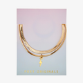 A set of two gold bracelets, one layered over the other, with a lightning bolt charm hanging from the bottom. The bracelets are displayed on a pink card with the brand name "Foxy Originals."
