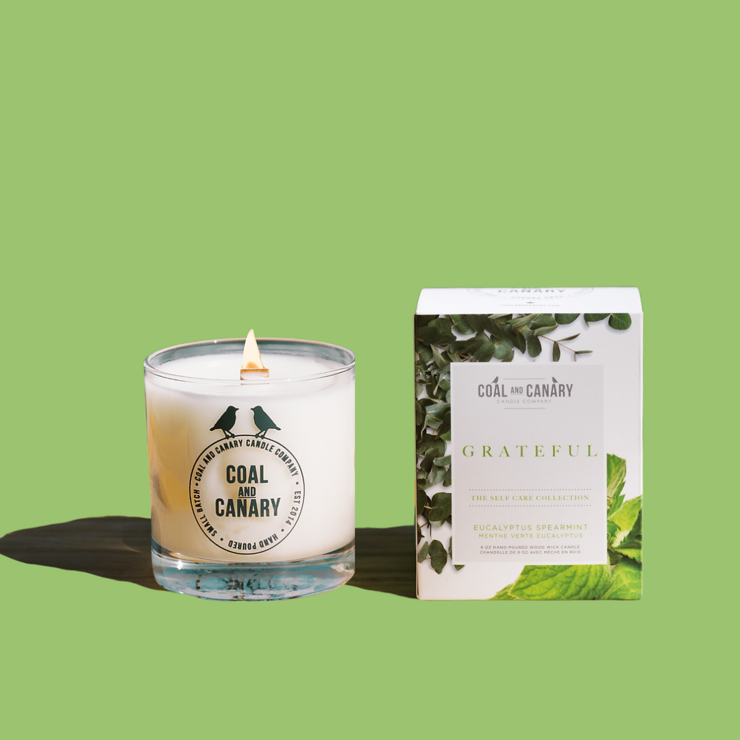 Grateful Candle, a glass jar candle with a wood wick.